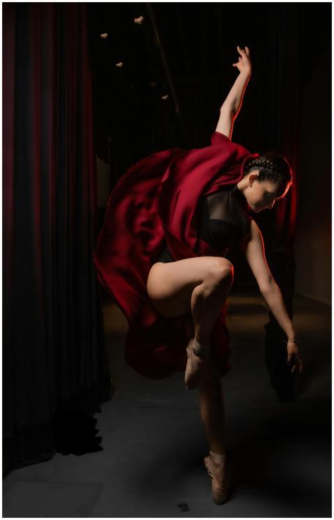 A graceful ballet dancer performs a dynamic and el