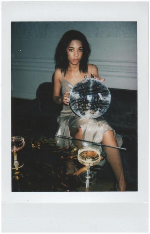 Stylish woman in evening dress with disco ball at