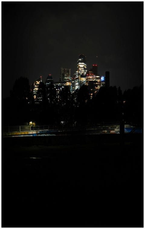A dramatic night view of London's skyline with ill