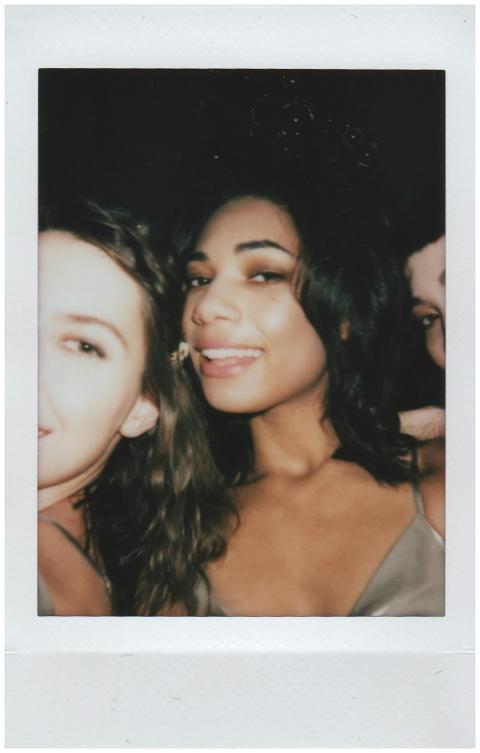 A candid instant photo capturing joyful friends at