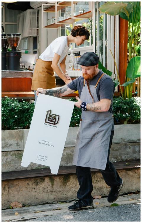 Employees setting up an outdoor sign at a modern c
