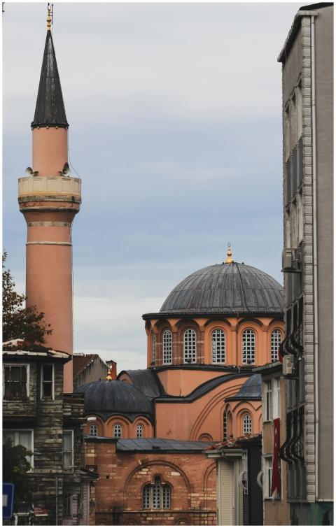 View of a historic mosque with a minaret in an urb
