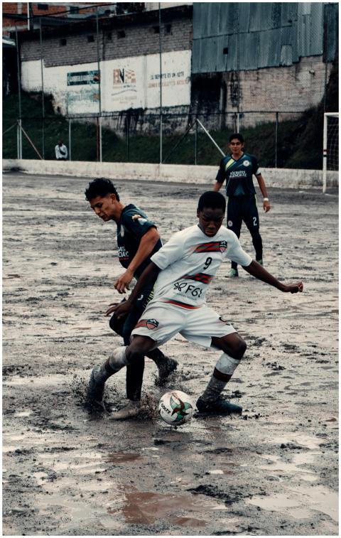 Players engage in a passionate soccer game on a mu