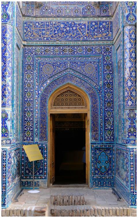 Stunning blue mosaic tiles adorn an arched entranc