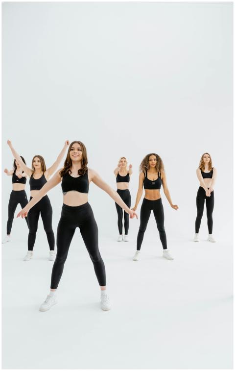 Women in activewear perform synchronized exercises