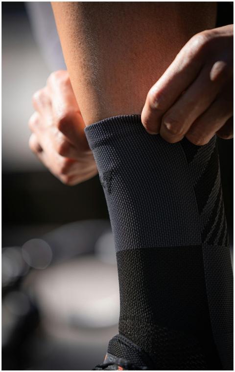 Detailed close-up of a person adjusting a gray ath