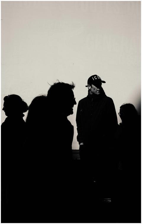 Silhouetted people against a light background, cre