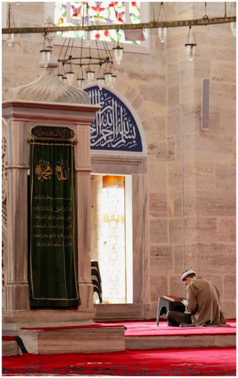A man peacefully praying inside a traditional mosq