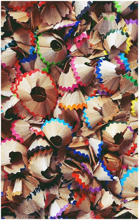 A collage of colorful pencil shavings creating a v