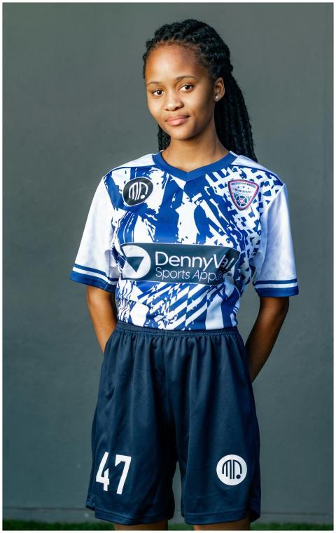 Young African-American woman in sports jersey posi