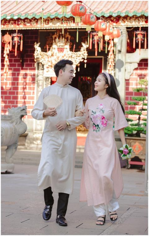 A couple in traditional Vietnamese ao dai walking