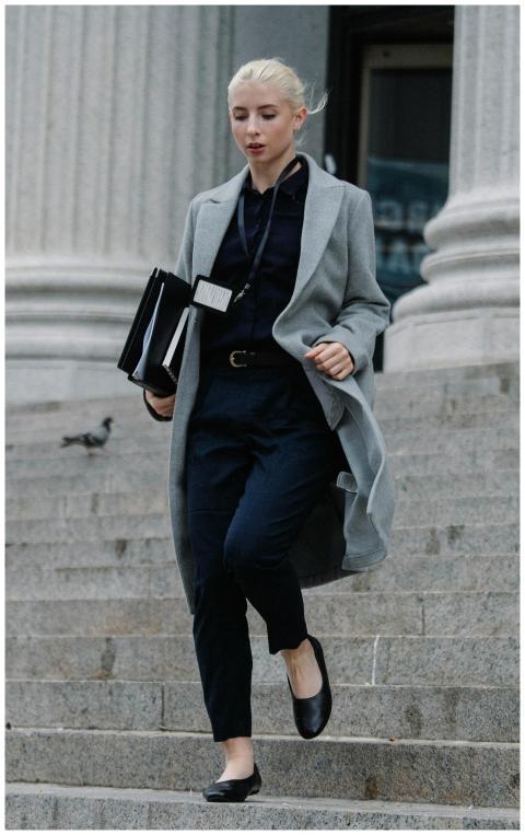 A stylish woman in business attire descends city s