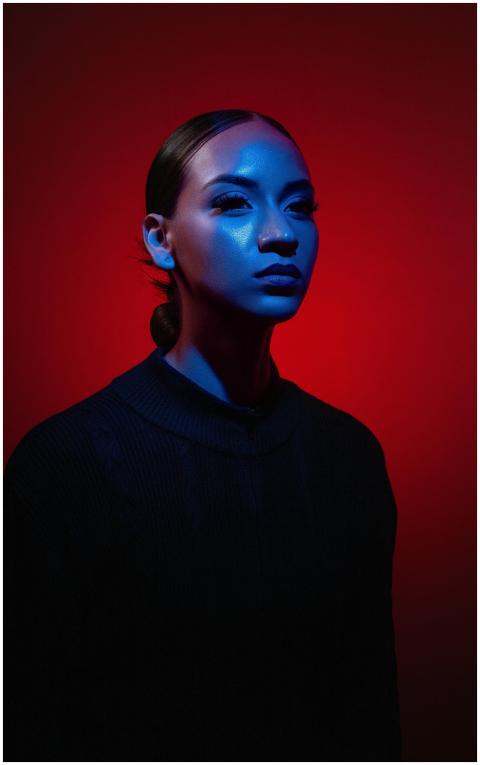 Intense portrait of woman in blue and red lighting