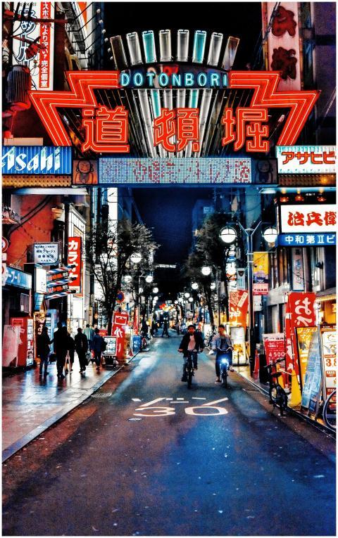 Explore the neon-lit streets of Dotonbori in Osaka