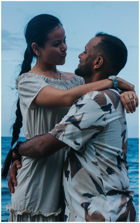 A loving couple embraces by the sea in Venezuela,