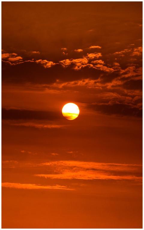 Vivid orange sunset with dramatic clouds in Ica, P