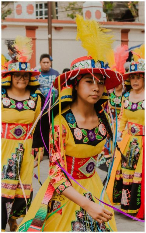 A group of people in bright traditional costumes p