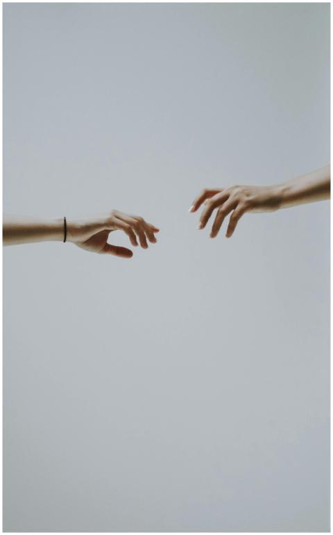 A minimalistic photo of two hands reaching out to