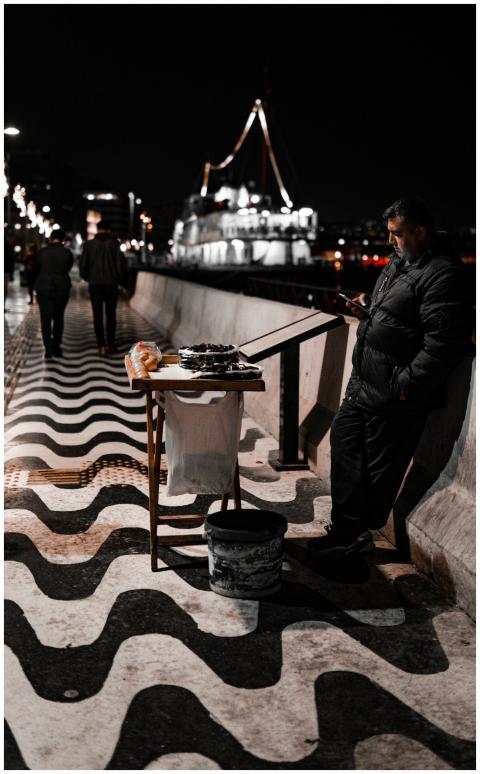 Street vendor sells goods on a vibrant urban walkw