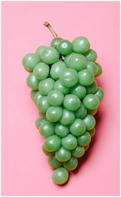 From above of cluster of fresh juicy ripe green gr