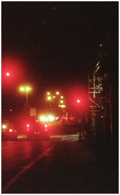 Atmospheric nighttime city street with car lights