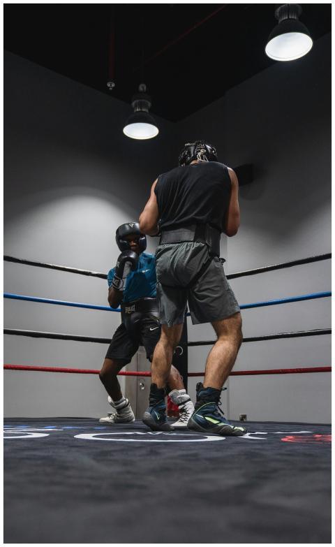 Two athletes in a boxing ring engaged in a fierce