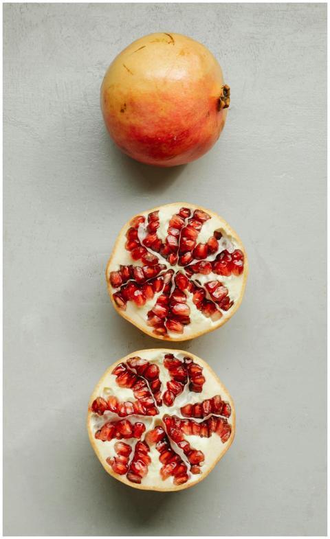 Top view of composition of ripe fresh red pomegran