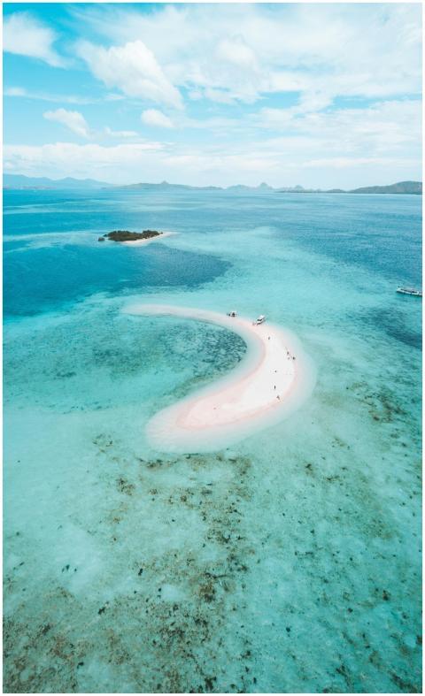 A stunning aerial view of a pink beach surrounded
