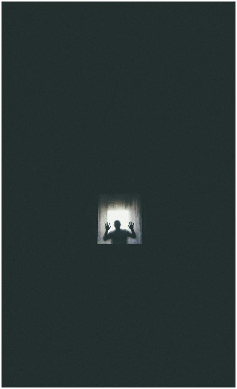 Eerie silhouette of a person against a window, con