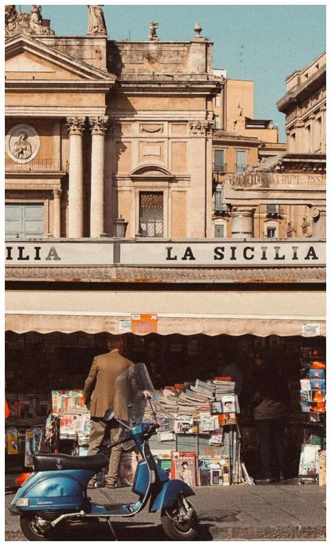 Charming Sicilian street scene with a kiosk, scoot