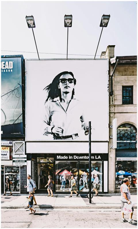 Busy Toronto street with shops, people, and large