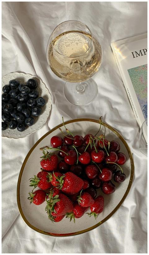 A top view of fresh strawberries, cherries, and bl