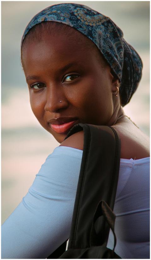 A serene portrait of a smiling woman in Dakar, Sen