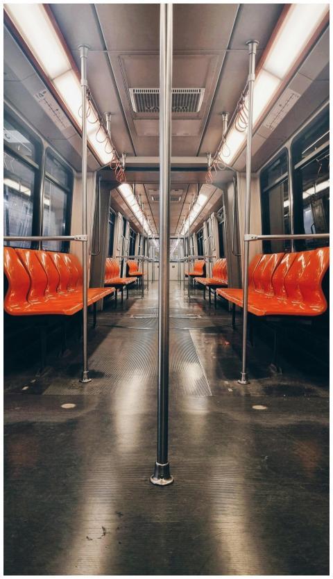Interior view of an empty subway car with striking