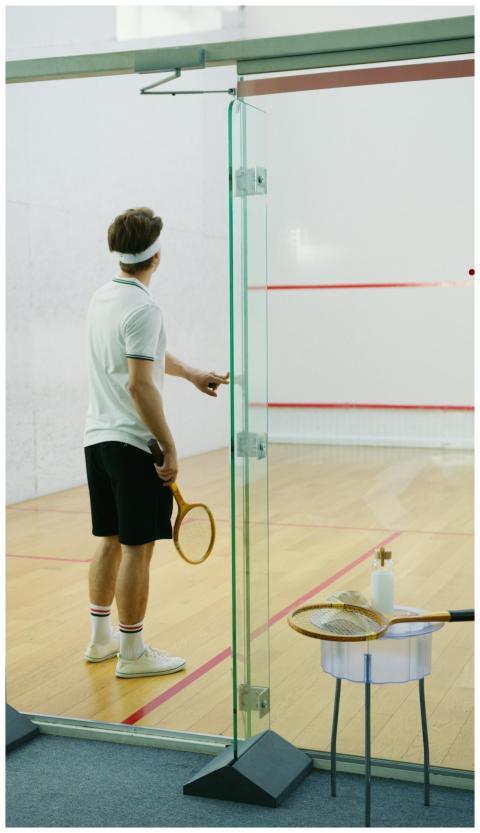 Athlete in a squash court preparing for a game wit