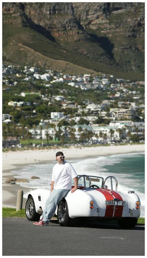 Person with classic car enjoying scenic view of Ca