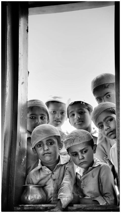 A group of children in traditional attire gazing t