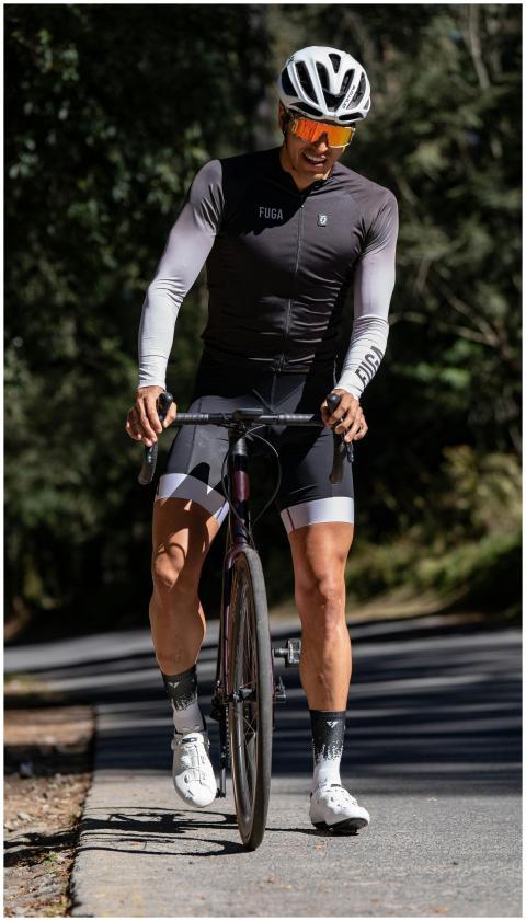 Male cyclist in professional gear riding through a