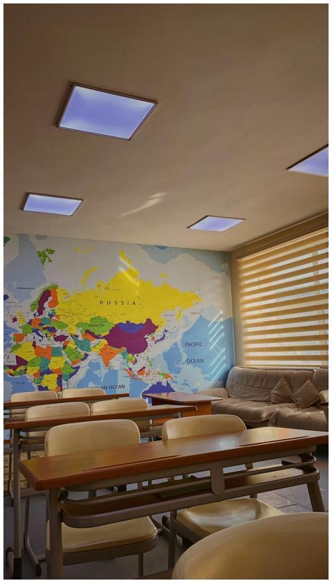 Colorful classroom with a world map wall mural and