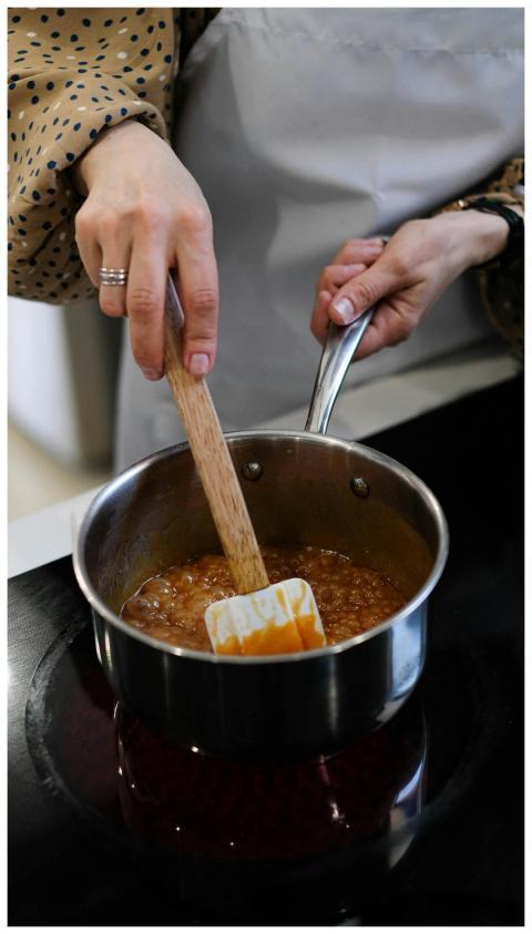 Close-up of a person preparing caramel sauce in a