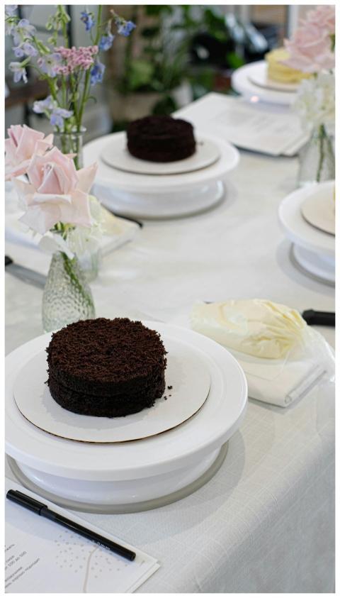 Elegant chocolate cake setup on a table with flora