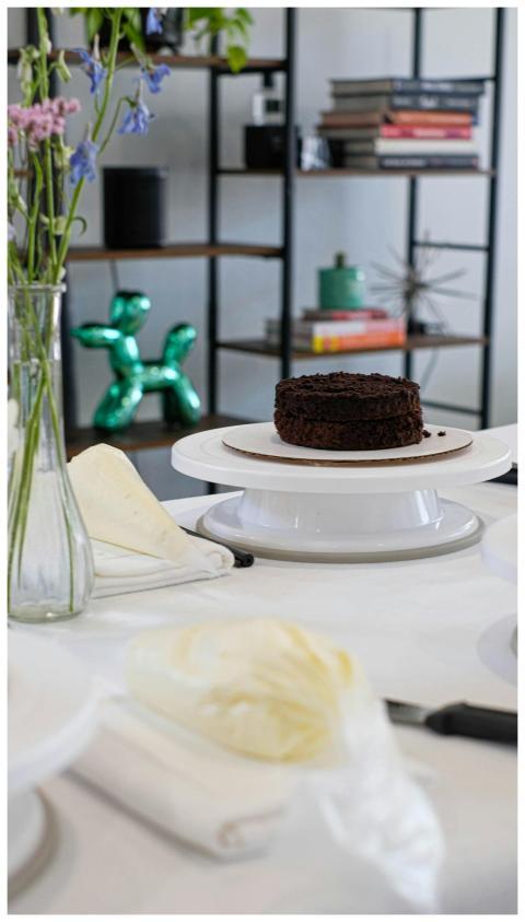 Indulge in a rich chocolate cake set on a stylish