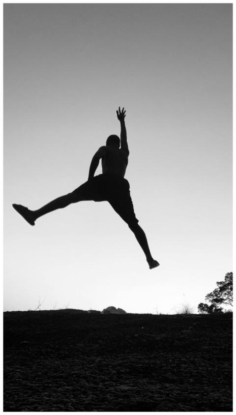 Silhouette Man Leaping Against