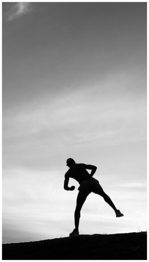 Silhouette Runner Kicking Sunset