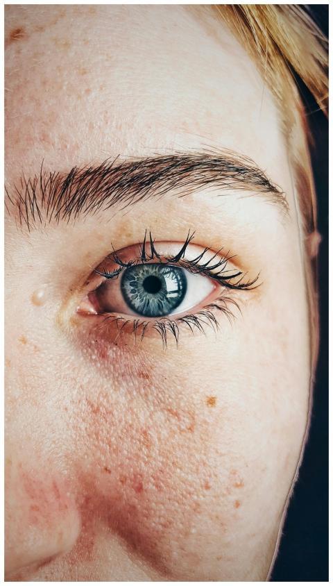 Detailed close-up of a woman's blue eye showcasing