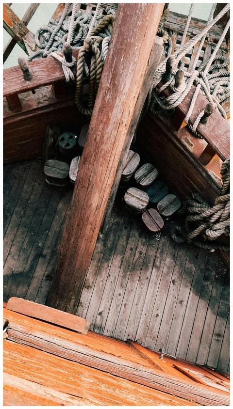 Aerial shot of a vintage wooden ship deck with rop