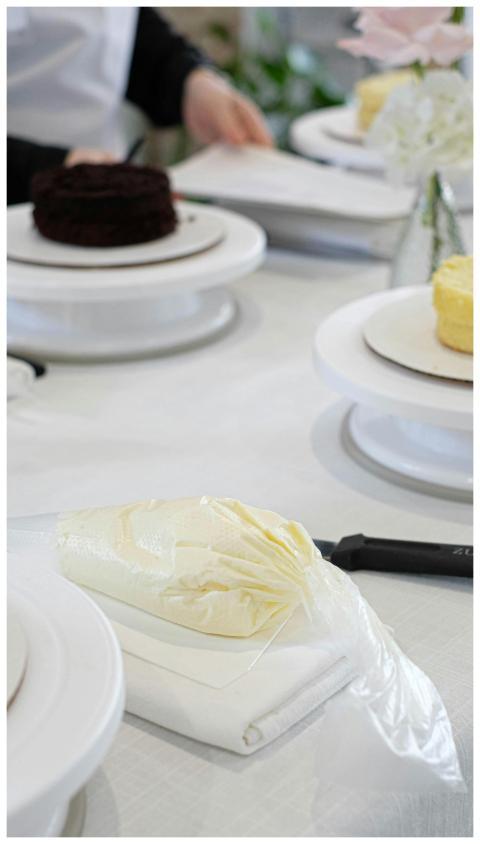Close-up of cake decorating process with creamy ic
