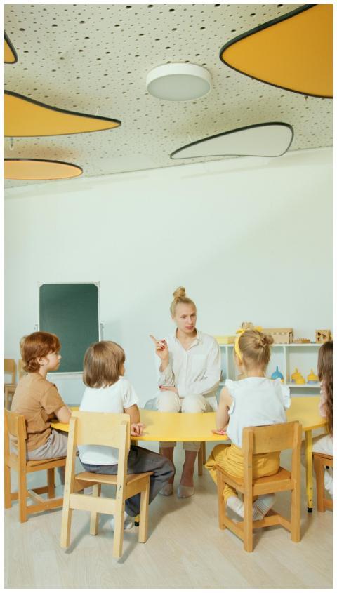 Children gathered around a teacher in a vibrant, m