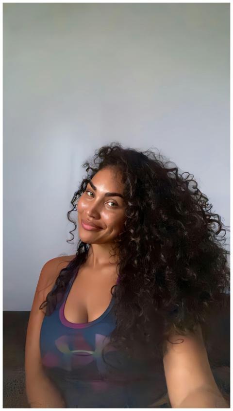 Portrait of a smiling woman with curly hair indoor