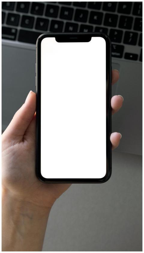 A close-up of a hand holding a smartphone with a b